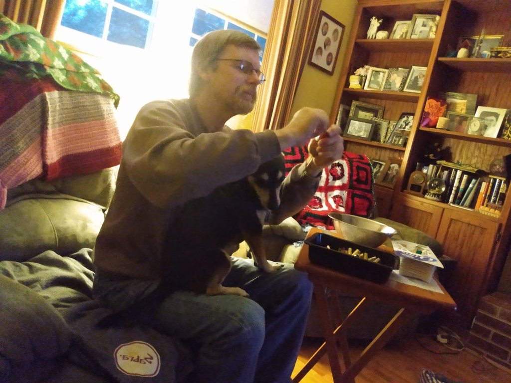 Buster helping me inspect 45 colt brass.jpg