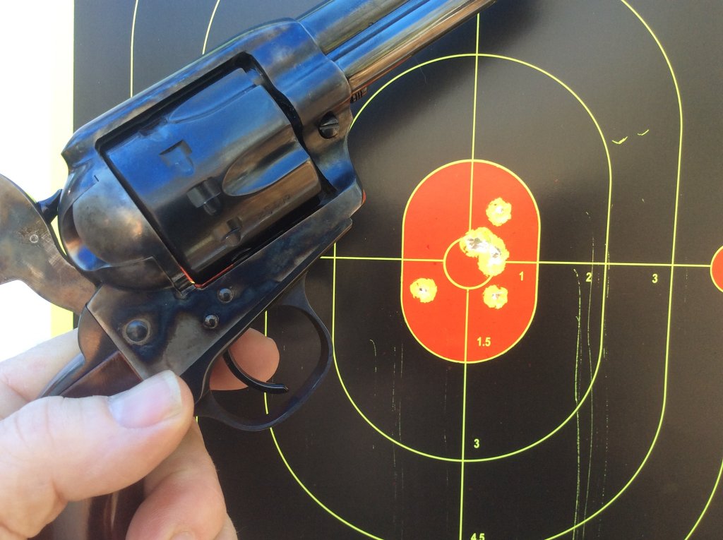 Cattleman 22 target  7 shots fired with 2 going thru ragged hole.jpg