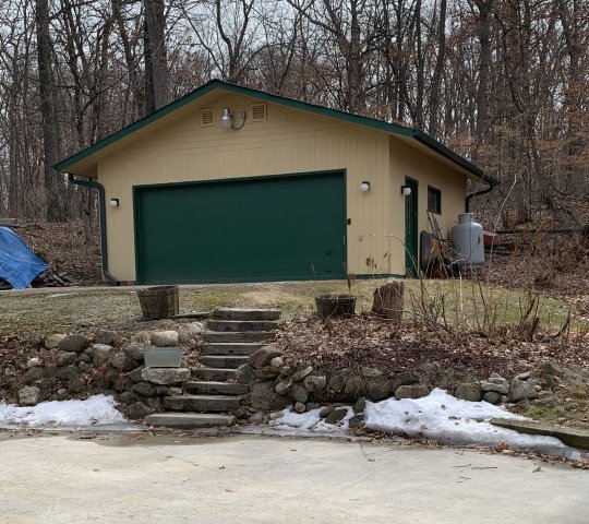 This is m y shop that sits on the hill to the right of the house.